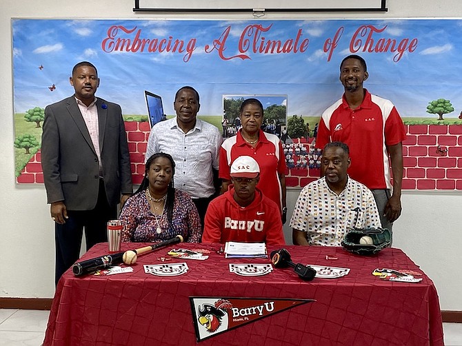 STANDING: Guidance counsellor Stephan Walkin, Physical Plant manager/track and field coach William Johnson, immediate past principal Sonja Knowles, and Physical Education Department head Jason Edwards. SITTING: Jacqueline Foster, Malik Foster and Michael Foster.