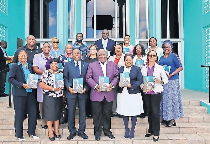 FORMER Prime Minister Hubert Ingraham presented copies of his book to 40 school principals. He is pictured with Grand Bahama primary school principals.