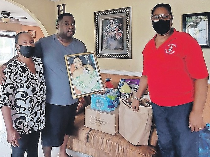 GB FNM Women’s Association president Kathy Munnings (left) and Vanessa Scott, National Women’s Association president (right) deliver items to Drew Burrows, the son of Ann Burrows.