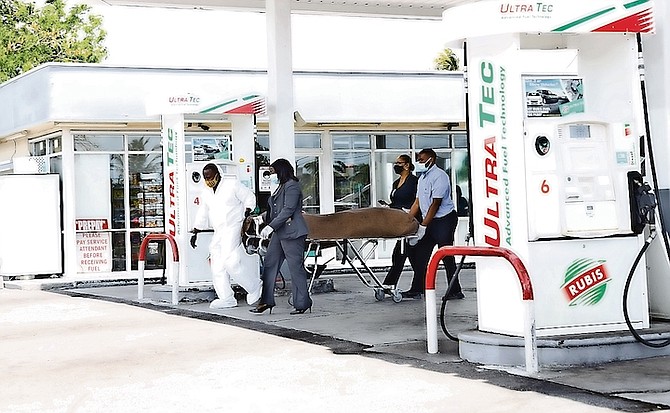 POLICE on the scene of a homicide at the Rubis gas station on Mackey Street yesterday.
Photo: Racardo Thomas/Tribune Staff