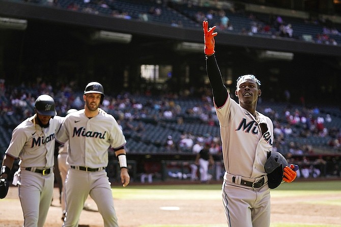 MIAMI Marlins’ Jazz Chisholm Jr, right, celebrates his three-run home run against the Arizona Diamondbacks with Marlins’ Jacob Stallings, middle, and Bryan De La Cruz, left, during the ninth inning of a baseball game last night in Phoenix. 
(AP Photo/Ross D Franklin)