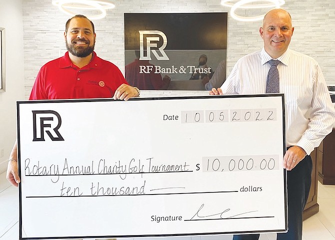 SHOWN, left to right, are Christian Knowles, vice president and director of funding at Rotary Club of
East Nassau, and David Van Onselen, RF vice president of financial advisory services.