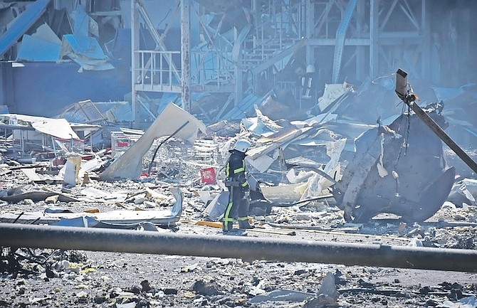 A UKRAINIAN firefighter works near a destroyed building on the outskirts of Odesa, Ukraine,
Tuesday. (AP Photo/Max Pshybyshevsky)