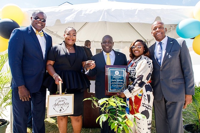 New homeowner Shante Taylor with (from left) South Beach MP Bacchus Rolle, Prime Minister Phillip “Brave” Davis, Minister of Housing and Transport Jobeth Coleby-Davis and Works and Utilities Minister Alfred Sears. Photo: Office of the Prime Minister