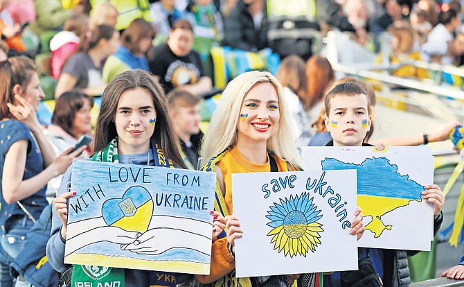 UKRAINE'S supporters hold anti-war banners before the UEFA Nations League soccer match between Ireland and Ukraine at the Aviva Stadium in Dublin, Ireland, yesterday. Photo: Peter Morrison/AP