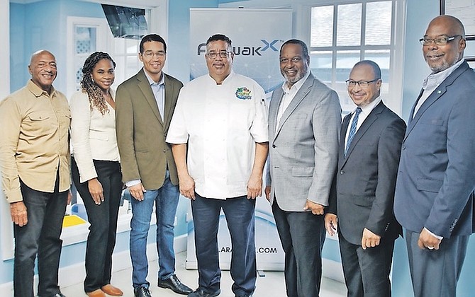 L to R: Kenneth Donathan, vice-president of investor relations, ArawakX; Nadia Butler, chief compliance officer, ArawakX; D’Arcy Rahming Jr, chief technology officer, ArawakX; Chef Kevin Culmer, co-founder, Tropical Gyros; D’Arcy Rahming Sr, chief executive, ArawakX; Michael Turnquest, ArawakX; Winston Rolle, vice-president of equities, ArawakX.