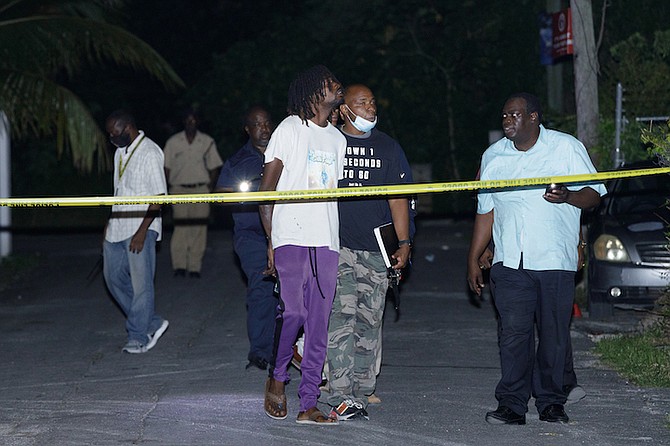 POLICE investigate the shooting incident in the area of Fleming Street that led to the death of a young boy. Officers are pictured with the reported brother of the victim.
Photo: Austin Fernander