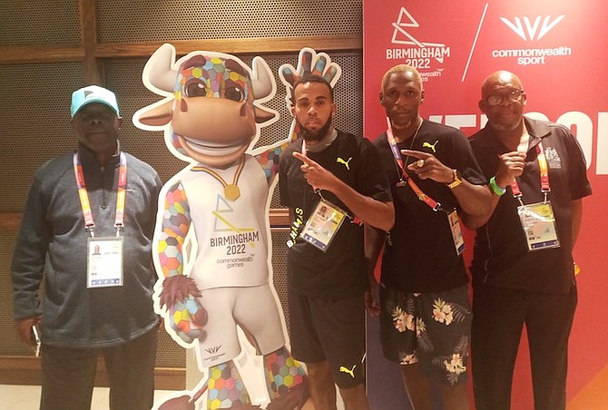 CHEF de mission Roy Colebrooke, far left, boxers Rashield Williams and Carl Hield, and coach Vincent Strachan, far right, stand beside the Commonwealth Games mascot.