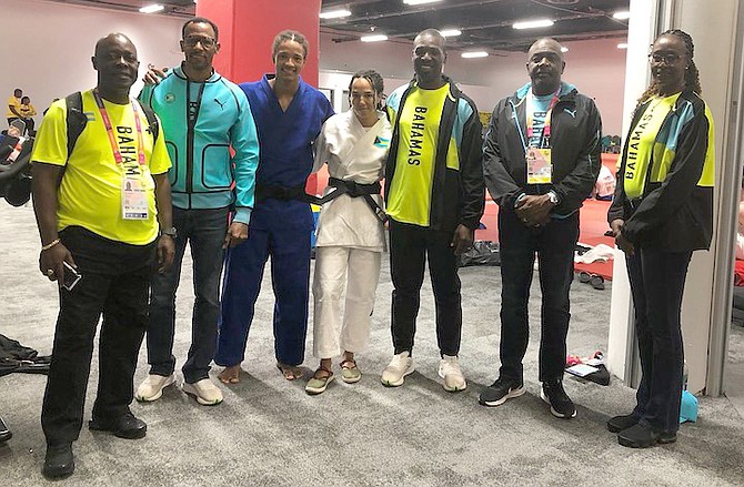 TEAM EFFORT: Bahamian judokas Cynthia Rahming and Andrew Munnings didn’t fare as well as they had anticipated in the judo competition yesterday at the Commonwealth Games. But with the
support of Minister of Youth, Sports and Culture Mario Bowleg, chef de mission Roy Colebrooke, Munnings’ father Tim Munnings and Natasha Miller, the duo - coached by Willard McKenzie - felt they
both gave a good account of themselves.