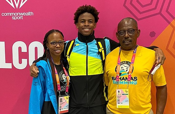 LAMAR TAYLOR, centre, with his parents Gena and Lester Taylor after his historic swim at the Commonwealth Games.
