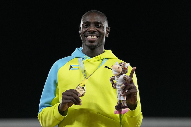 MAKING HISTORY: Laquan Nairn, of The Bahamas, poses on the podium after winning the gold medal in the long jump final during the athletics competition in the Alexander Stadium at the Commonwealth Games in Birmingham, England, on Thursday, August 4, 2022.
(AP Photos/Alastair Grant)