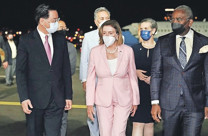 US HOUSE SPEAKER Nancy Pelosi, centre, walks with Taiwan’s Foreign Minister Joseph Wu, left, as she arrives in Taipei, Taiwan. 
(Taiwan Ministry of Foreign Affairs via AP)
