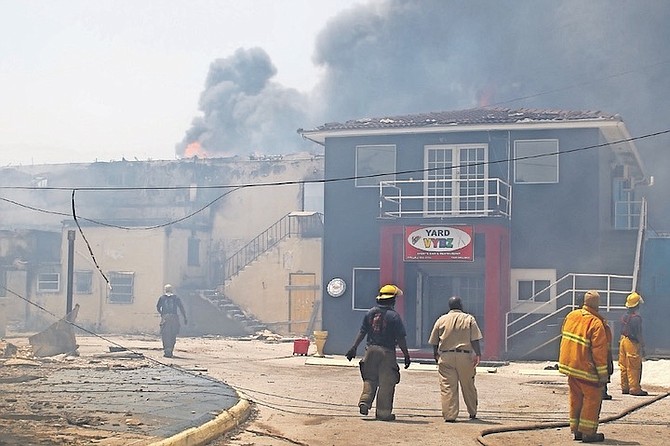 FIREFIGHTERS tackling the blaze that struck the International Bazaar in Grand Bahama again on Tuesday. Photo:Vandyke Hepburn