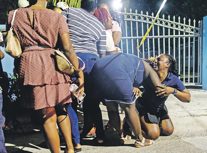MOURNERS at the scene last night after gunmen opened fire at a baby shower, killing one man and injuring four boys.
Photo: Austin Fernander