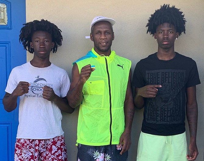 HEAD coach Carl Hield is flanked by boxers Jalen Young and Jaiden Young.