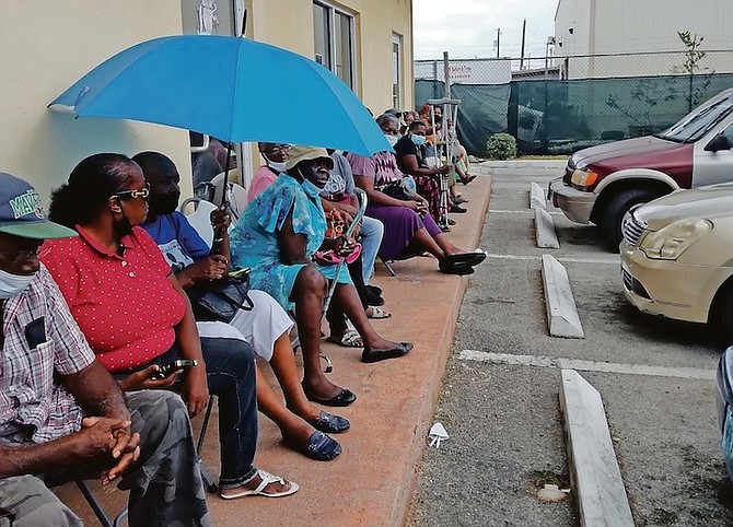 Waiting for food coupons in Grand Bahama yesterday.
Photos: Denise Maycock/Tribune Staff