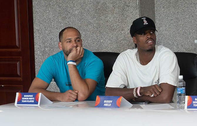 CHAVANO “Buddy” Hield (right) of the NBA’s Indiana Pacers, and former pro player Mychel Thompson Jr look on during a press conference ahead of Team Bahamas’ game against Venezuela tonight in the FIBA Americas Cup Qualifier at the Kendal Isaacs Gymnasium. 
Photo: Moise Amisial/Tribune Staff