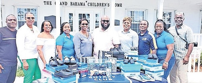 MEMBERS of the Rotary Club of Grand Bahama presented shoes to the Grand Bahama Children’s Home on Friday, kicking off the first phase of The Blue Shoe Project, an initiative to provide new and gently used shoes to children and students with special needs on Grand Bahama. Seen centre is President Donovan Bowe, along with June Hutcheson (fifth from the left), executive director of the Grand Bahama Children’s Home.