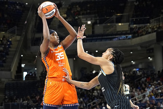 Connecticut Sun forward Jonquel Jones, left, looks to pass as Chicago Sky forward Candace Parker defends during the first half of Game 2 in a WNBA basketball playoffs semifinal Wednesday, in Chicago. (AP Photo/Nam Y. Huh)