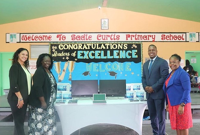 SADIE Curtis Primary School principal Sheanda Mackey and staff accept electronic devices from Nassau Village MP Jamahl Strachan.
Photo: Verline Mackey