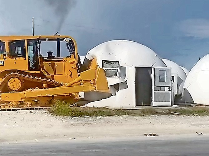 A BULLDOZER moves in to demolish domes in Abaco. Photos: Silbert Mills
