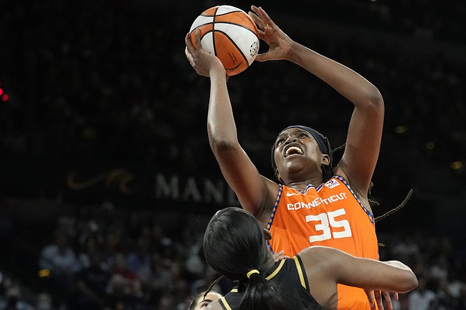SUN forward Jonquel Jones shoots against the Las Vegas Aces during the second half in Game 2 of the WNBA Finals series last night in Las Vegas. She posted a double double.
(AP Photo/John Locher)