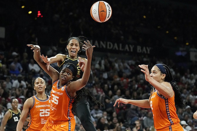 CONNECTICUT Sun forward Jonquel Jones (35) battles for the ball with Las Vegas Aces forward A’ja Wilson (22) during the first half in Game 2 of the WNBA Finals series on Tuesday night in Las Vegas. Las Vegas leads the best-of-five series 2-0 heading into Game 3 against the Sun at 9pm tonight in Connecticut. 
(AP Photo/John Locher)