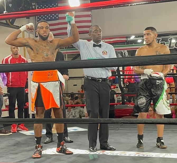 RASHIELD Williams’ arm is raised by the ring referee after he won his fight on Saturday.