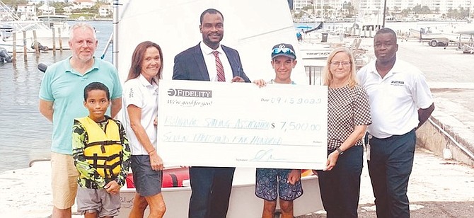 SHOWN, from left to right, Alan Loane, commodore of The Nassau Yacht Club, sailor William Bain, Emma Tinkler, regatta chair, Akone Cumberbatch, Fidelity Bank Donations Committee member, sailor Zane Munro, Lori Lowe, president of The Bahamas Sailing Association and Antonio Saunders, Fidelity Bank marketing and media manager.