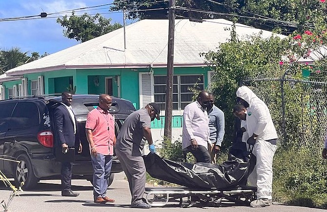 Police remove the body from the scene on Wednesday. Photo: Earyel Bowleg