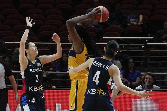 Bosnia and Herzegovina's Jonquel Jones attempts to pass the ball as South Korea's Kang Leeseul, left, and Yoon Yebin, right, block during their game at the women's Basketball World Cup in Sydney, Australia, Saturday, Sept. 24, 2022. (AP Photo/Mark Baker)