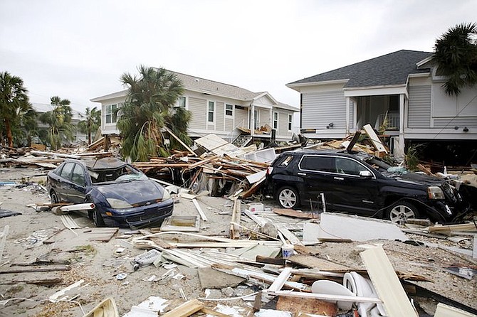 Remnants of damaged homes and flooded vehicles are seen in Fort Myers Beach, Florida, on Thursday, following Hurricane Ian. (Douglas R. Clifford/Tampa Bay Times via AP)