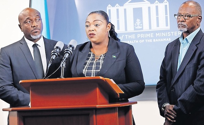 STATE Minister of Social Services and Urban Development Lisa Rahming speaking yesterday as Charron Penn, project manager and strategic advisor Arthur Johnson look on. Photo: Austin Fernander