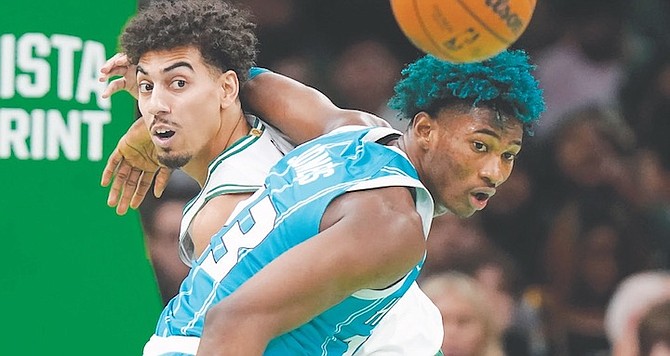 CELTICS’ BRODRIC THOMAS, left, and Hornets’ Kai Jones, right, pursue the ball in their preseason game yesterday in Boston.
(AP Photo/Steven Senne)