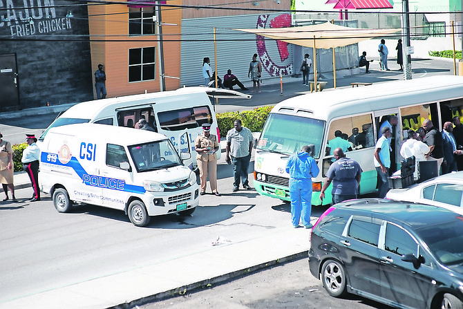 Police at the scene of the shooting on Robinson Road after a bus driver was killed and a 16-year-old was injured. Photo: Moise Amisial