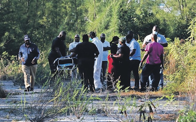 OFFICERS at the scene where a partially decomposed body was found in Freeport yesterday. Photo: Vandyke Hepburn