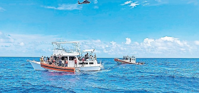 US Coast Guard law enforcement crews aiding people from an unsafe and overloaded 40-foot cabin cruiser about 20 miles off Boca Raton, Florida, on October 12.