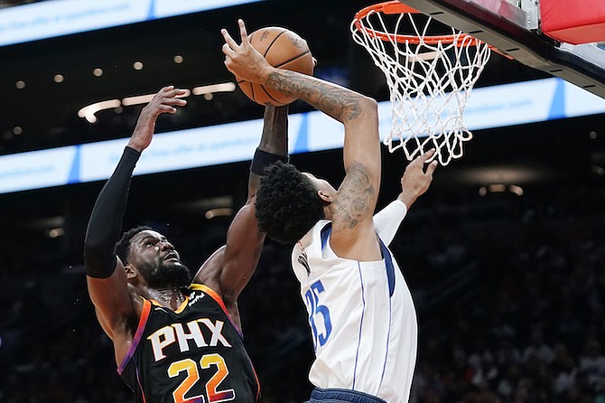 Phoenix Suns centre Deandre Ayton (22) blocks the shot of Dallas Mavericks centre Christian Wood, right, during the first half of an NBA basketball game in Phoenix, Wednesday. (AP Photo/Ross D. Franklin)