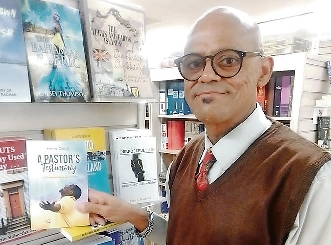 PASTOR Kenny Carroll at Logos Book store with his book, A Pastor’s Testimony.