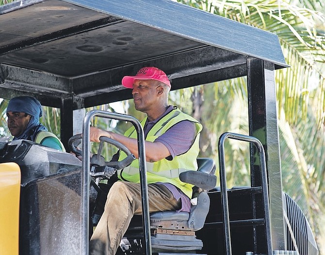 WORKS Minister Alfred Sears operating a paving machine in Exuma on Friday during his visit to examine infrastructure work. Photos: Moise Amisial