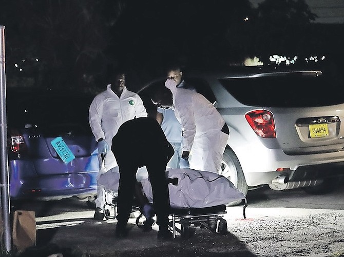 A BODY is removed from the scene of the shooting in Kool Acres. Photo: Austin Fernander