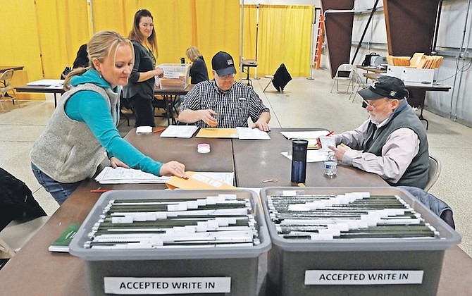 ELECTION workers sort through ballots at the Flathead County Fairgrounds in Kalispell, Montana, on Wednesday. Photo: Tommy Martino/AP