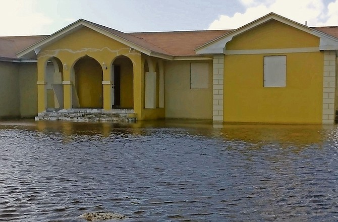Flooding outside the home of Errol Miller in West End, Grand Bahama, yesterday. Mr Miller said he “noticed the (sea) water starting to come over the seawall”.
Photo: Denise Maycock/Tribune Staff