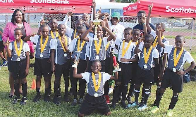 SOCCER CHAMPIONS: The Sybil Strachan Primary Mighty Warriors show off all their hardware. The boys earned an impressive 5-1 victory over Claridge Primary to win the Bahamas Football Association’s New Providence Public Primary Sports Association boys’ soccer title. Photo courtesy of the BFA