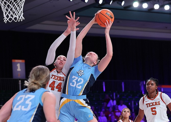 MARQUETTE’S Liza Karlen (32) goes up against Texas’ Taylor Jones (44) on Saturday during their NCAA college basketball game in the Battle 4 Atlantis at the Atlantis resort on Paradise Island. 
Photo: Tim Aylen/Bahamas Visual Services via AP)