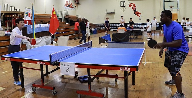 CHINESE ambassador Dai Qingli in action against Bahamas Table Tennis Federation youth director Sudan Khalfani.