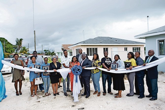 PRIME Minister Philip “Brave” Davis and Housing Minister JoBeth Coleby-Davis along with new homeowners at yesterday’s ceremony. Photo: Moise Amisial