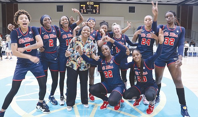 BAHAMIAN coach Yolett McPhee-McCuin and her Ole Miss Rebels celebrate last night after winning their opening game of the Baha Mar Hoops Pink Flamingo Championship at the Baha Mar resort. Ole Miss stayed undefeated in five games this season, sealing an impressive 63-50 win over the Dayton Flyers. 
Photos: Austin Fernander/Tribune Staff