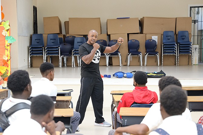 STRIKERS Boxing Club founder Ronn Rodgers talks to students of CR Walker Secondary High School during a special session in the T Nicola McKay Auditorium. 
Photos: Austin Fernander/Tribune Staff