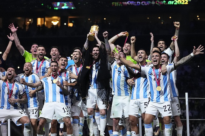 Argentina's Lionel Messi holds up the trophy after winning the World Cup final soccer match between Argentina and France at the Lusail Stadium in Lusail, Qatar, Sunday. (AP Photo/Manu Fernandez)